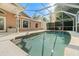 A sparkling swimming pool is surrounded by a screened enclosure, enhancing outdoor enjoyment at 775 Brittany Park Blvd, Tarpon Springs, FL 34689