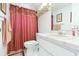 Bathroom featuring a shower with a red curtain, vanity, and modern fixtures at 8215 Hixton Dr, Port Richey, FL 34668