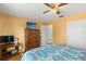 Bright bedroom with yellow walls, wood floor, dresser, and an entertainment setup in this well lit room at 8215 Hixton Dr, Port Richey, FL 34668