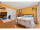 Bedroom with an orange accent wall, closet, and desk with computer at 8215 Hixton Dr, Port Richey, FL 34668