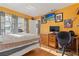 Bedroom with yellow walls, wood floor, and computer on desk at 8215 Hixton Dr, Port Richey, FL 34668