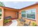 A charming front porch featuring an outdoor sitting area and decorative planters at 8215 Hixton Dr, Port Richey, FL 34668