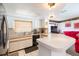 Bright kitchen featuring a counter with barstool seating, white cabinets, and black appliances at 8215 Hixton Dr, Port Richey, FL 34668