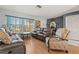 Living room featuring leather furniture, natural light, and an accent chair at 8215 Hixton Dr, Port Richey, FL 34668