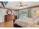Comfortable main bedroom with an entertainment center and sliding glass doors out to the pool and patio at 8215 Hixton Dr, Port Richey, FL 34668