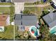 Aerial view of backyard with pool, patio, fire pit, and fenced yard at 8326 Archwood Cir, Tampa, FL 33615