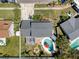 Aerial view of backyard with pool, patio, fire pit, and fenced yard at 8326 Archwood Cir, Tampa, FL 33615