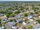 Wide aerial view of a residential neighborhood with mature trees, waterways, and single-Gathering homes at 8326 Archwood Cir, Tampa, FL 33615
