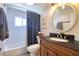 Updated bathroom with white subway tile, dark vanity and anchor themed decor at 8326 Archwood Cir, Tampa, FL 33615
