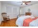 Bedroom featuring hardwood floors, ceiling fan, and charming rocking chair at 8326 Archwood Cir, Tampa, FL 33615