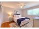 Bedroom with decorative pillows, area rug, and a ceiling fan above the bed at 8326 Archwood Cir, Tampa, FL 33615