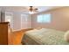 Bright bedroom featuring hardwood floors, ceiling fan and double door closet at 8326 Archwood Cir, Tampa, FL 33615
