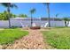 The backyard fire pit offers a cozy gathering spot, surrounded by lush lawn and landscaping at 8326 Archwood Cir, Tampa, FL 33615
