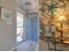Charming entryway featuring blue front door and coastal decor, setting a welcoming tone for the home, with luxury vinyl floors at 8326 Archwood Cir, Tampa, FL 33615