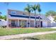 Charming two-story home with lush lawn, tasteful landscaping, and beautiful palm trees; a welcoming sight for potential buyers at 8326 Archwood Cir, Tampa, FL 33615