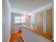 A sunlit hallway with hardwood floors and crown molding at 8326 Archwood Cir, Tampa, FL 33615