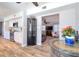 View of the stylish kitchen with modern white cabinets, stainless steel appliances, and backsplash, through an open-concept interior at 8326 Archwood Cir, Tampa, FL 33615