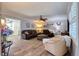 Comfortable living room with luxury vinyl floors, a leather sectional, and an open layout flowing into the dining and kitchen at 8326 Archwood Cir, Tampa, FL 33615