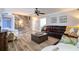 Spacious living room featuring wood-look floors, a large leather sectional, and coastal-themed decor; stairs in background at 8326 Archwood Cir, Tampa, FL 33615