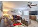 Comfortable living room with a plush sectional sofa, neutral colors, wood-look floors, and plantation shutters for privacy at 8326 Archwood Cir, Tampa, FL 33615