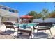The patio features outdoor seating around the pool in a comfortable area perfect for relaxing and enjoying the backyard at 8326 Archwood Cir, Tampa, FL 33615
