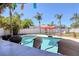 Outdoor pool view from the tiki bar with swaying palm trees in the Florida sunshine at 8326 Archwood Cir, Tampa, FL 33615