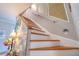 Coastal themed staircase featuring painted shiplap, wood steps, and sea-themed decor at 8326 Archwood Cir, Tampa, FL 33615