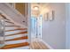 Staircase features a wooden railing, hardwood steps and floors, and white risers at 8326 Archwood Cir, Tampa, FL 33615