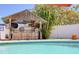 The backyard tiki bar and poolside offer a resort-style experience with its vibrant decor and refreshing pool at 8326 Archwood Cir, Tampa, FL 33615