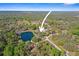 Aerial view of the property with lake frontage showcasing the home's setting amidst mature trees and natural beauty at 8403 Southwood Pines St, Lithia, FL 33547