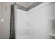 Bathroom featuring a white shower and decorative tile accents at 8403 Southwood Pines St, Lithia, FL 33547