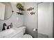 Modern bathroom featuring elegant white fixtures, unique fish decor, and updated walk-in shower at 8403 Southwood Pines St, Lithia, FL 33547