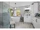 Bright bathroom with soaking tub under arched window, glass shower, and white vanity at 8403 Southwood Pines St, Lithia, FL 33547