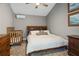 Comfortable bedroom with a king-size bed, a crib and soft lighting at 8403 Southwood Pines St, Lithia, FL 33547