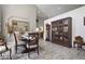 Dining room area with a wooden dining set, mirrored wall, and vintage china cabinet at 8403 Southwood Pines St, Lithia, FL 33547