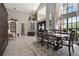 Elegant dining room with a grand staircase, high ceilings, and wooden dining set at 8403 Southwood Pines St, Lithia, FL 33547