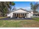 Exterior view features backyard patio seating with stylish furniture, enhancing the home's outdoor living space at 8403 Southwood Pines St, Lithia, FL 33547