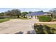 Exterior of home with solar panels on the roof and a long driveway at 8403 Southwood Pines St, Lithia, FL 33547