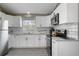 Kitchen with white cabinets, stainless steel appliances, subway tile backsplash, and granite countertops at 8403 Southwood Pines St, Lithia, FL 33547
