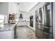 Spacious kitchen with stainless steel appliances, island, granite countertops, and bright white cabinetry at 8403 Southwood Pines St, Lithia, FL 33547