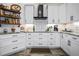 Modern kitchen with white cabinetry, granite countertops, and stainless steel appliances at 8403 Southwood Pines St, Lithia, FL 33547