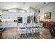 Spacious kitchen with white cabinetry, stainless steel appliances, and a granite island with bar stools at 8403 Southwood Pines St, Lithia, FL 33547