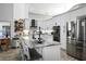 Stylish kitchen featuring white cabinets, a large island, and stainless steel appliances at 8403 Southwood Pines St, Lithia, FL 33547