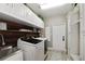 Functional laundry room featuring modern washer and dryer, storage cabinets, sink and convenient access at 8403 Southwood Pines St, Lithia, FL 33547