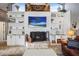 Cozy living room featuring a fireplace, built-in shelving, and a wall-mounted television at 8403 Southwood Pines St, Lithia, FL 33547