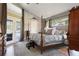 Comfortable main bedroom featuring a four-poster bed and access to the backyard at 8403 Southwood Pines St, Lithia, FL 33547