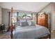 Spacious bedroom features a four-poster bed, high ceilings and a large arched window at 8403 Southwood Pines St, Lithia, FL 33547