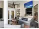 This covered patio features comfortable seating, a ceiling fan, and a fire pit, perfect for relaxation at 8403 Southwood Pines St, Lithia, FL 33547