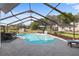 Sparkling pool in screened enclosure with outdoor dining and lush backyard at 8403 Southwood Pines St, Lithia, FL 33547