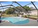 Beautiful in-ground pool with a screened enclosure and grassy backyard at 8403 Southwood Pines St, Lithia, FL 33547